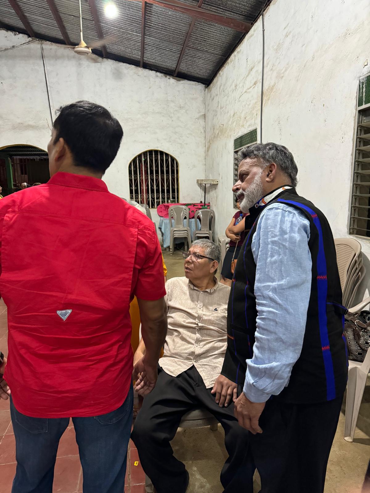 Praying with an elderly man in Nicaragua